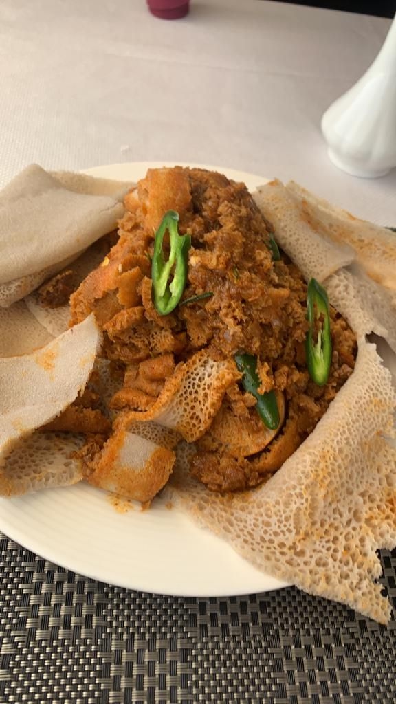 Firfir served on injera with green chilli