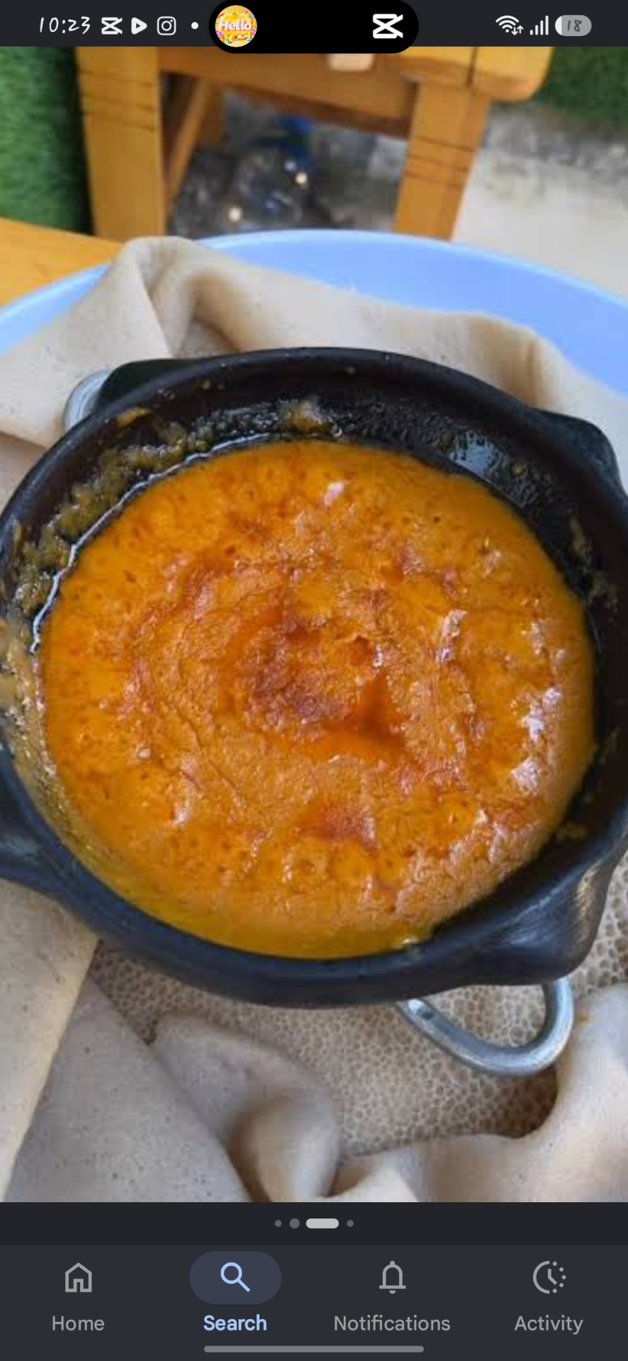 Shiro simmering in a black clay pot on injera
